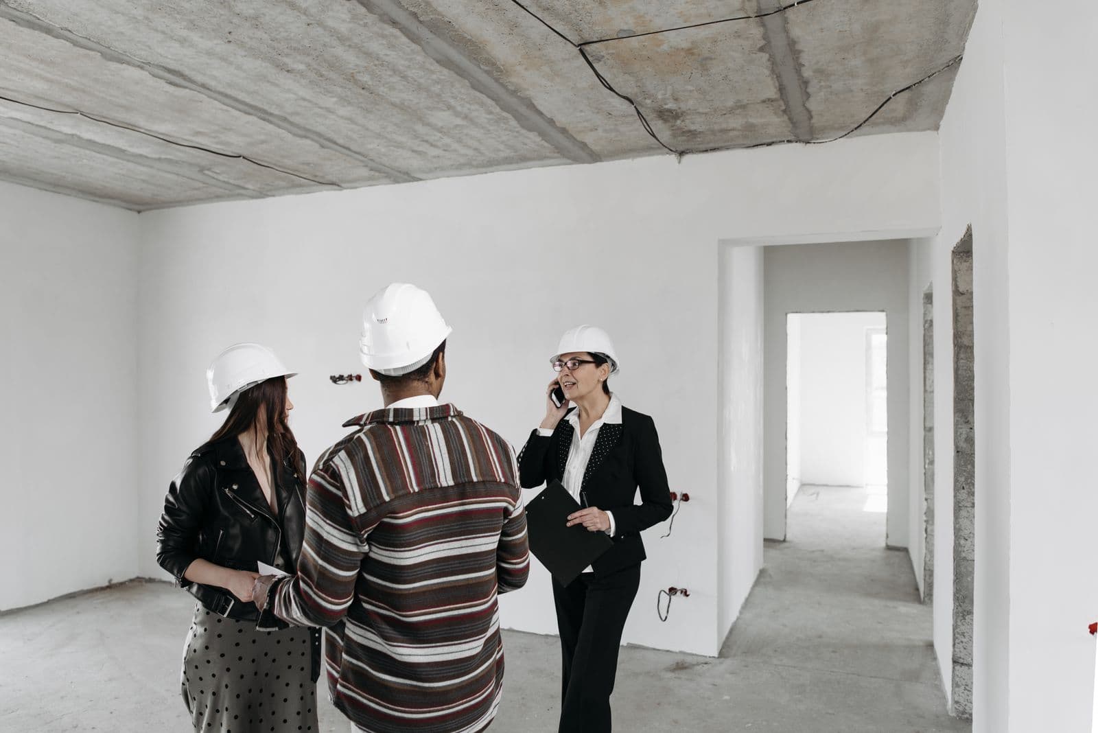 Contractor walking homeowners through a property during an on-site consultation